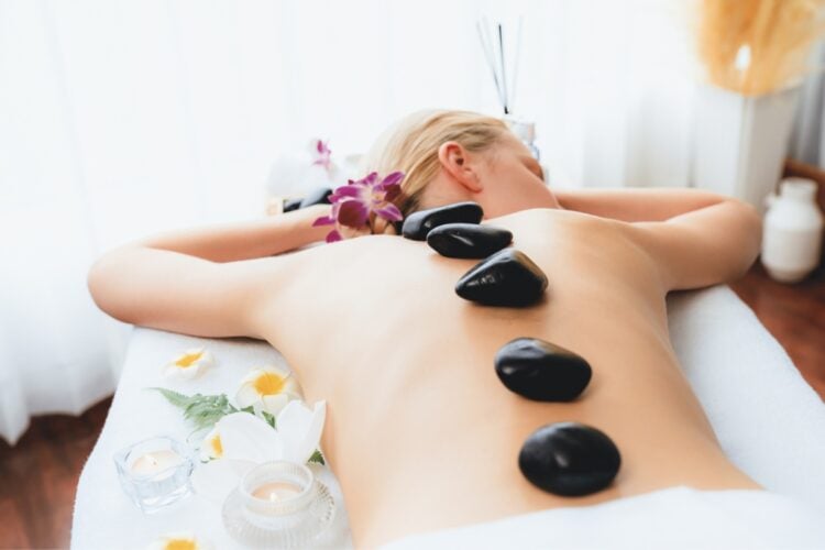 Hot stone massage at spa salon in luxury resort