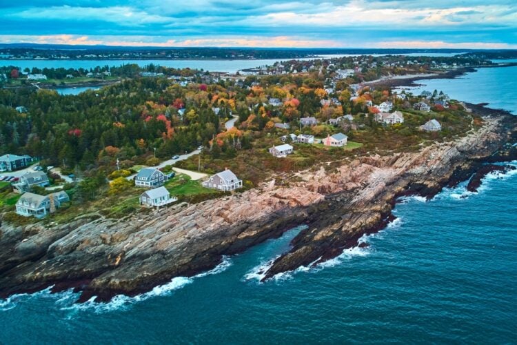 Image of Rocky cliffs and houses on islands of Harpswell Maine coast during dusk