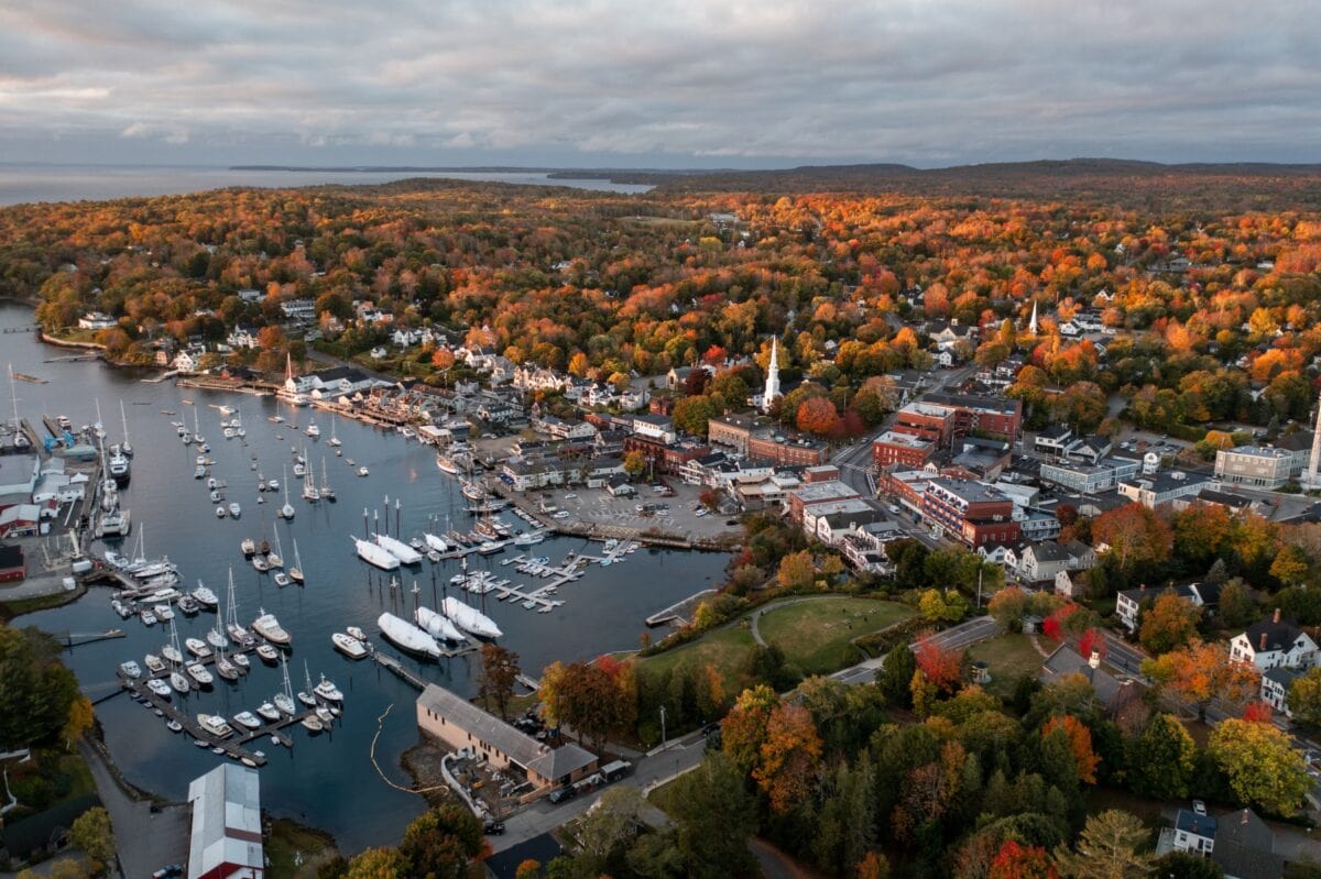 Panoramic view of sea harbor Camden, Maine town on east coast in New England, USA during sunrise in autumn season with fall foliage landscape